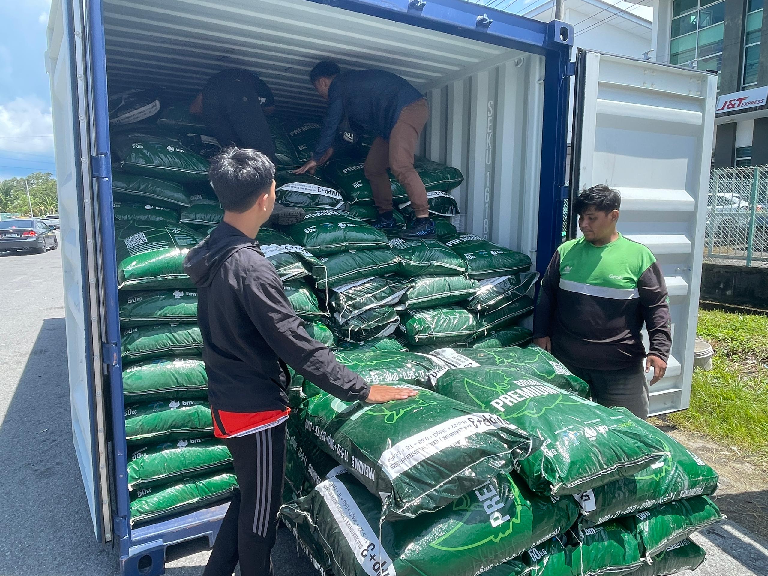 other instance of workers unstuffing packages from container